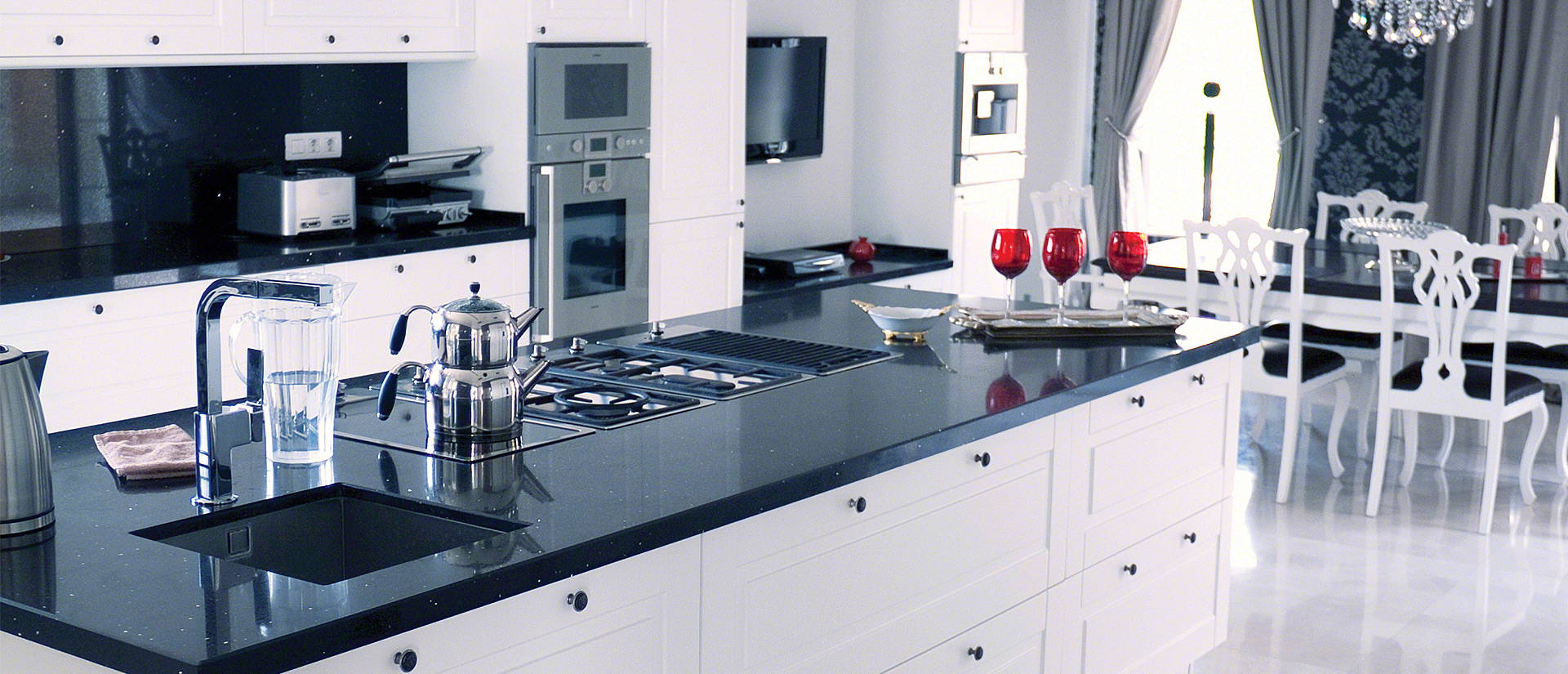 Clean black and white kitchen with Sparkling black quartz stone