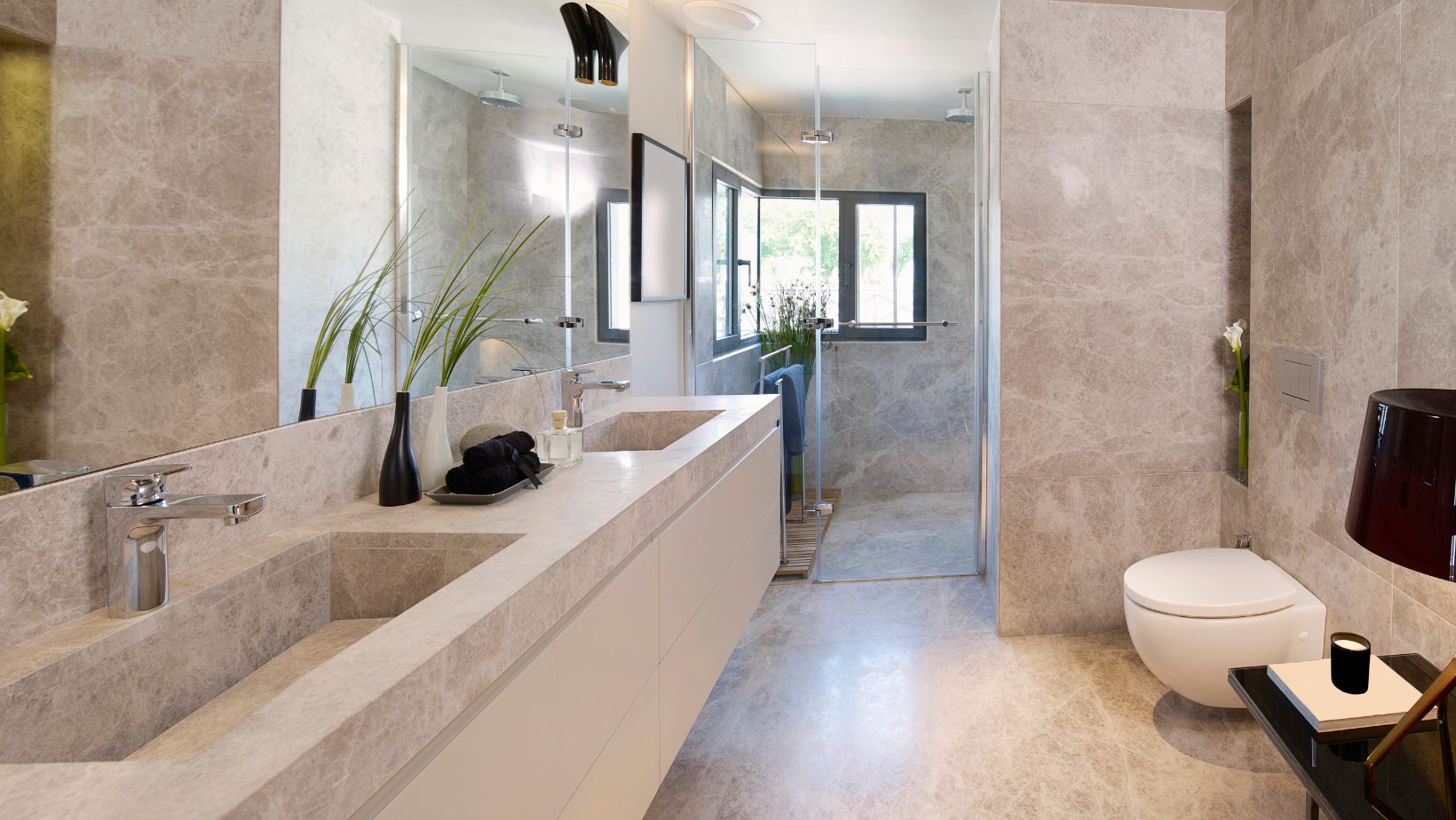 Elegant modern bathroom style with floating cream bathroom cabinets, a toilet and a shower