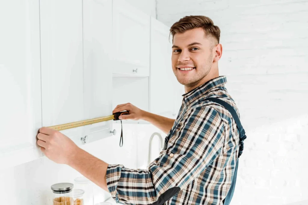 men measuring kitchen cabinets