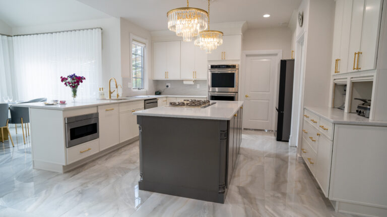 U shaped kitchen style with white cabinets and grey island