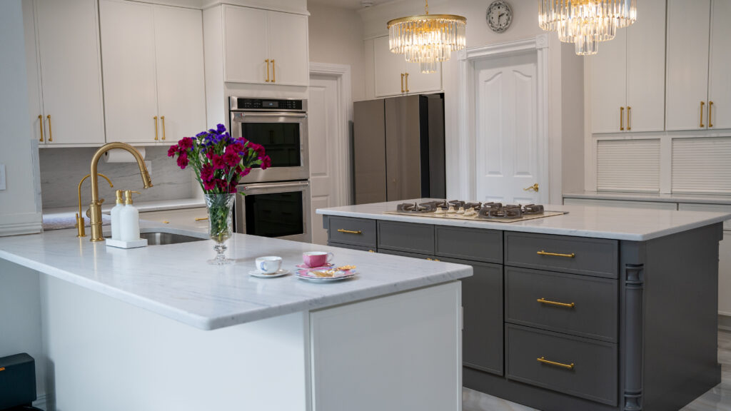 U shaped kitchen style with white cabinets and grey island
