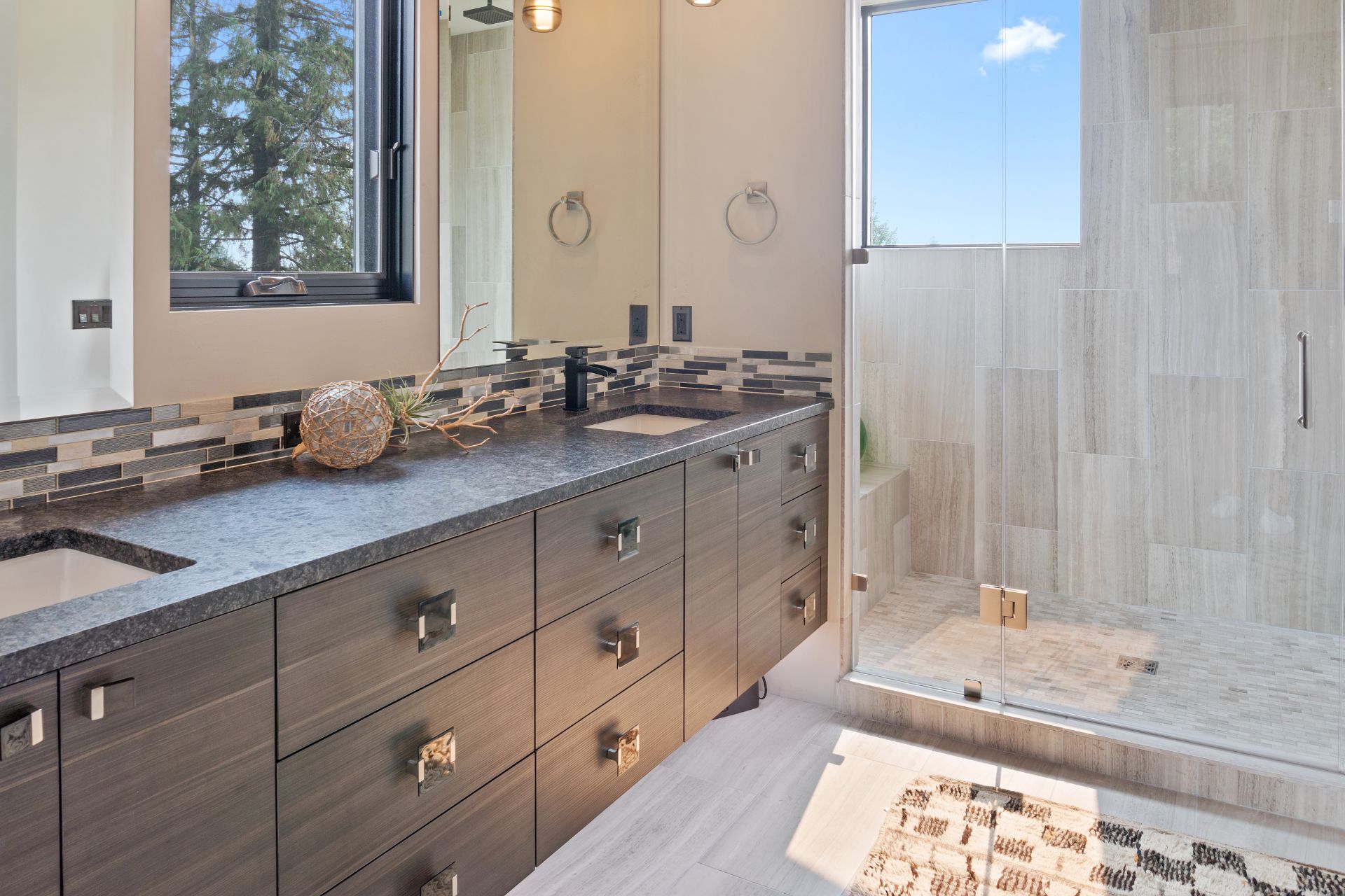 Modern bathroom style with double-sink dark brown vanity, and a shower