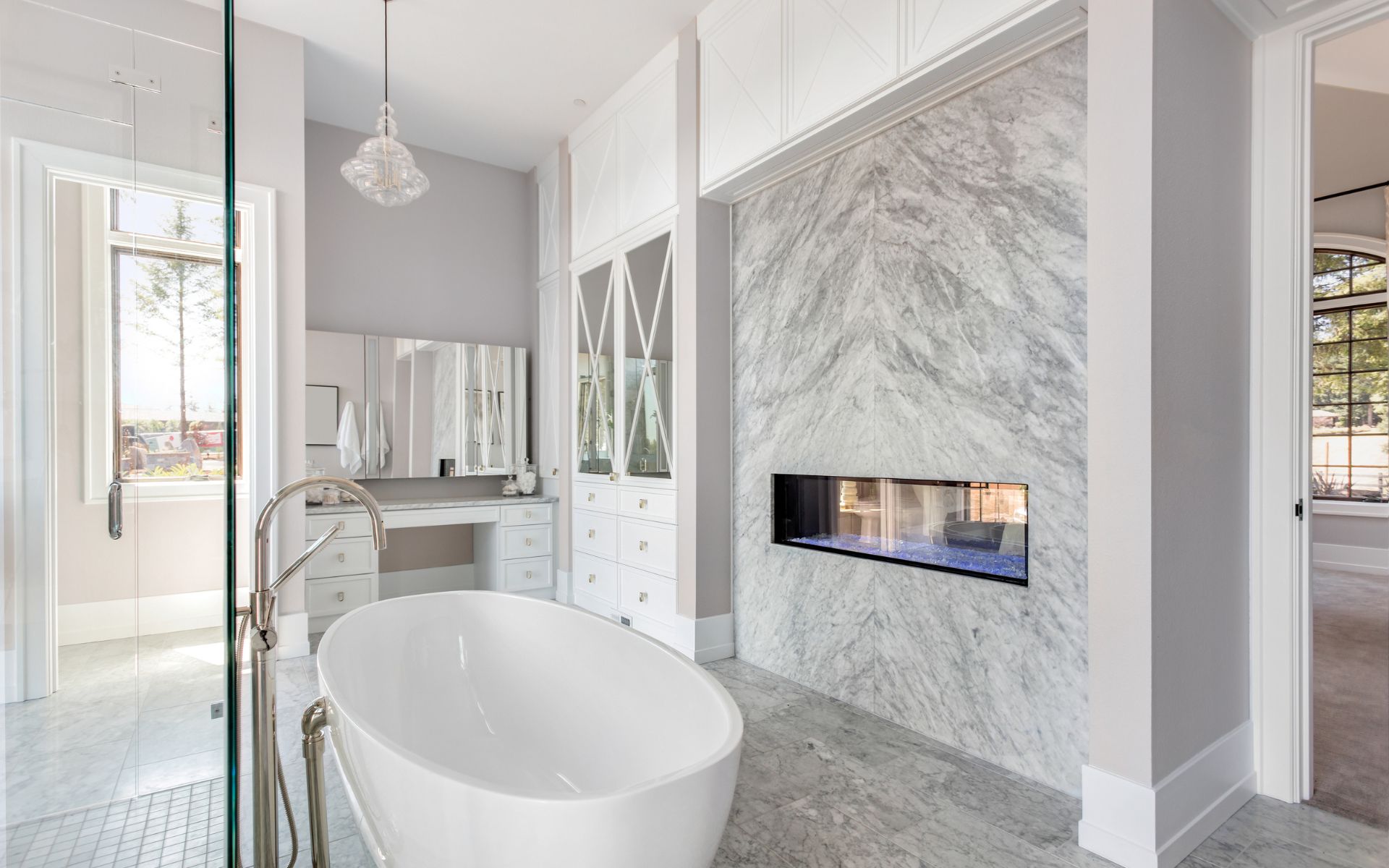 Elegant master bathroom design with tub, vanity, and wood flooring