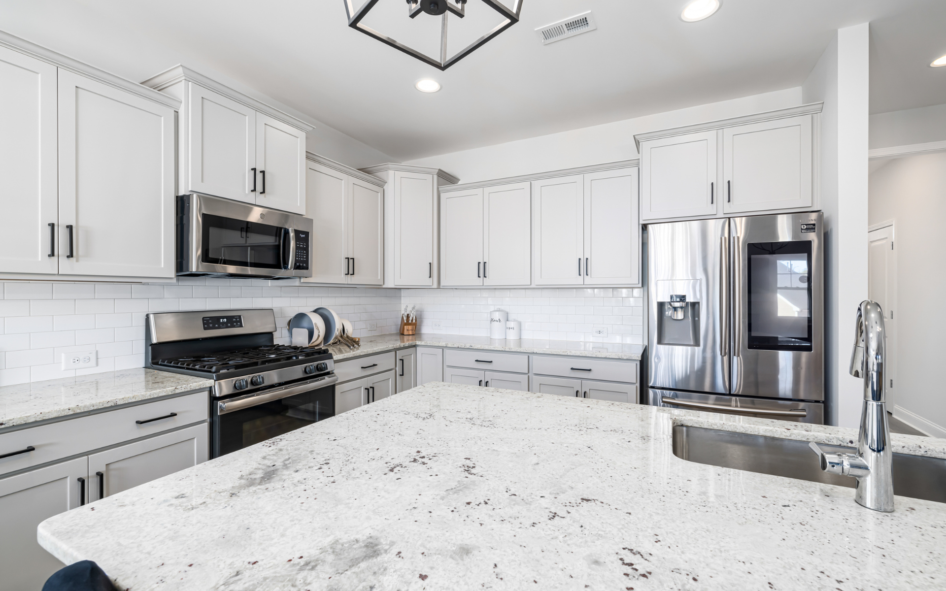 Elegant white kitchen with built-in appliances