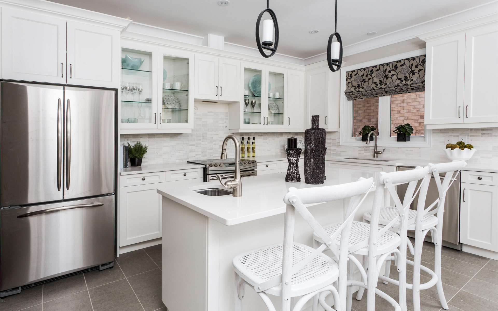 Elegant white kitchen with white cabinets and countertops