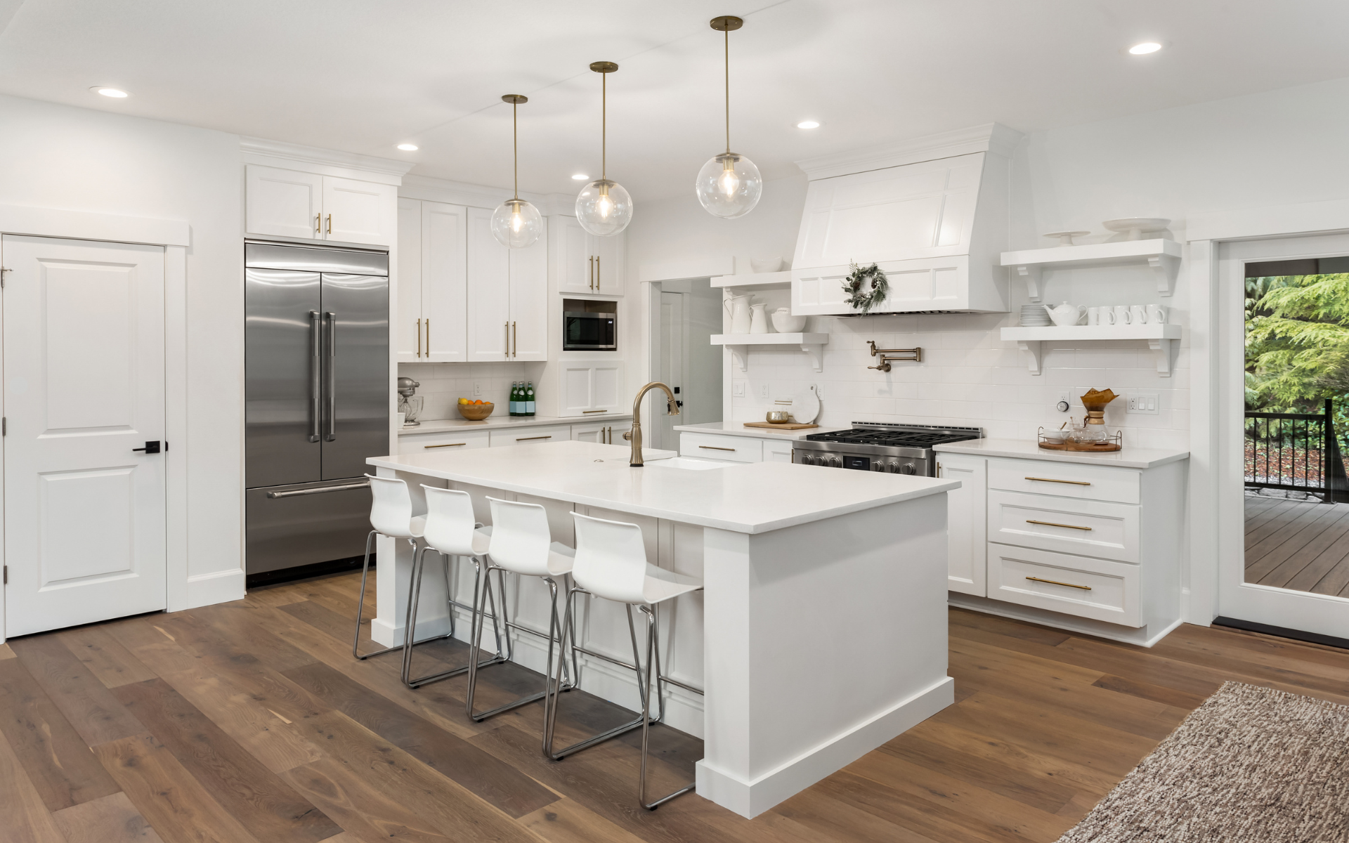 Bright kitchen with white cabinets, countertops, and wood flooring