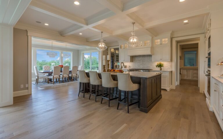 Spacious kitchen with wood oak flooring, white cabinets kitchen and bath contact