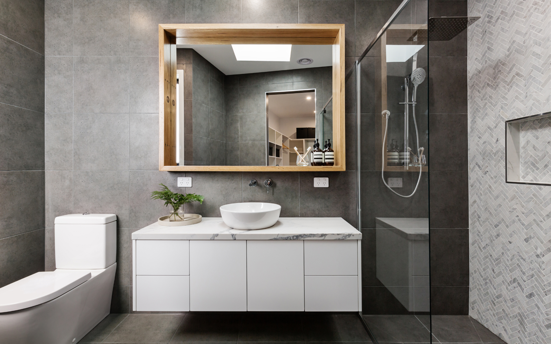 Elegant bathroom with floating white vanity, shower, and toilet