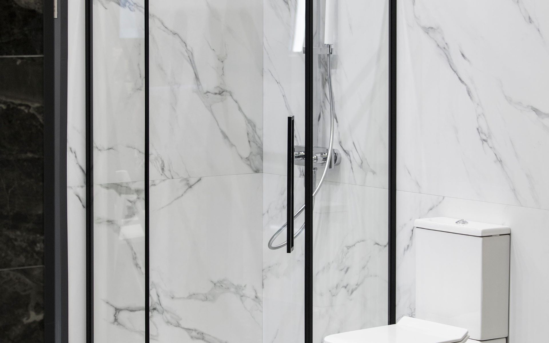 White shower with enclosed glass with metal frame