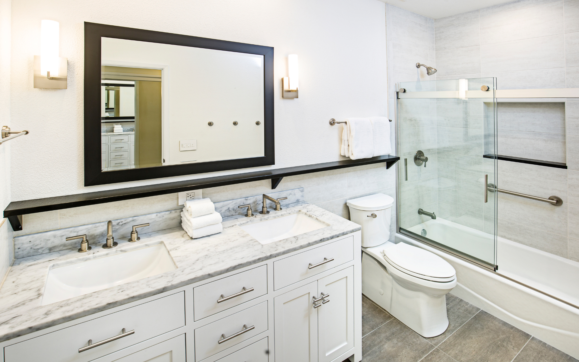 Bathroom with white vanity, toilet, and tub