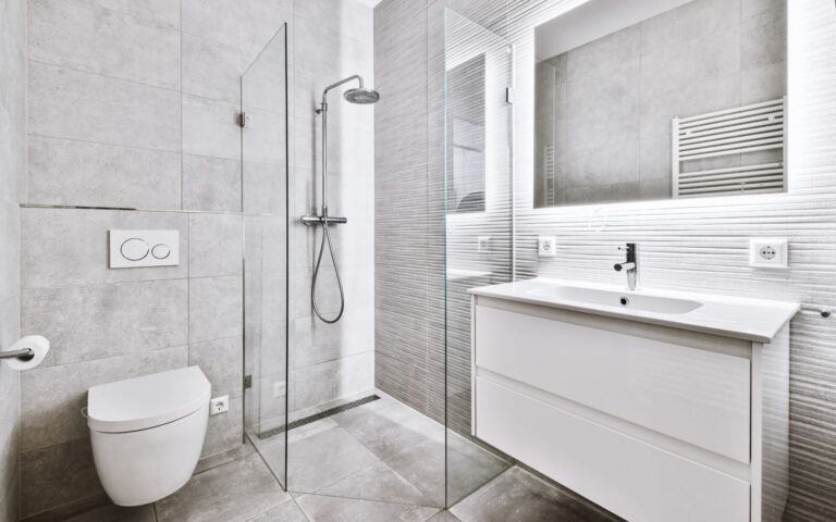 White bathroom with floating vanity and toilet, and doorless walk-in shower
