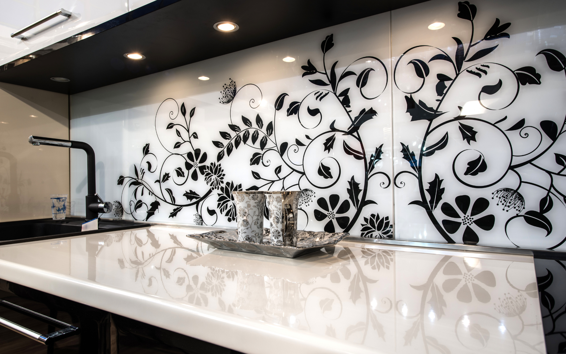 Elegant kitchen with glass backsplash and white countertop