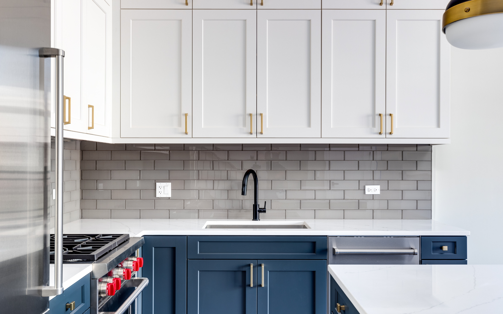 Elegant kitchen with white and blue cabinets and classic subway tiles for backsplash
