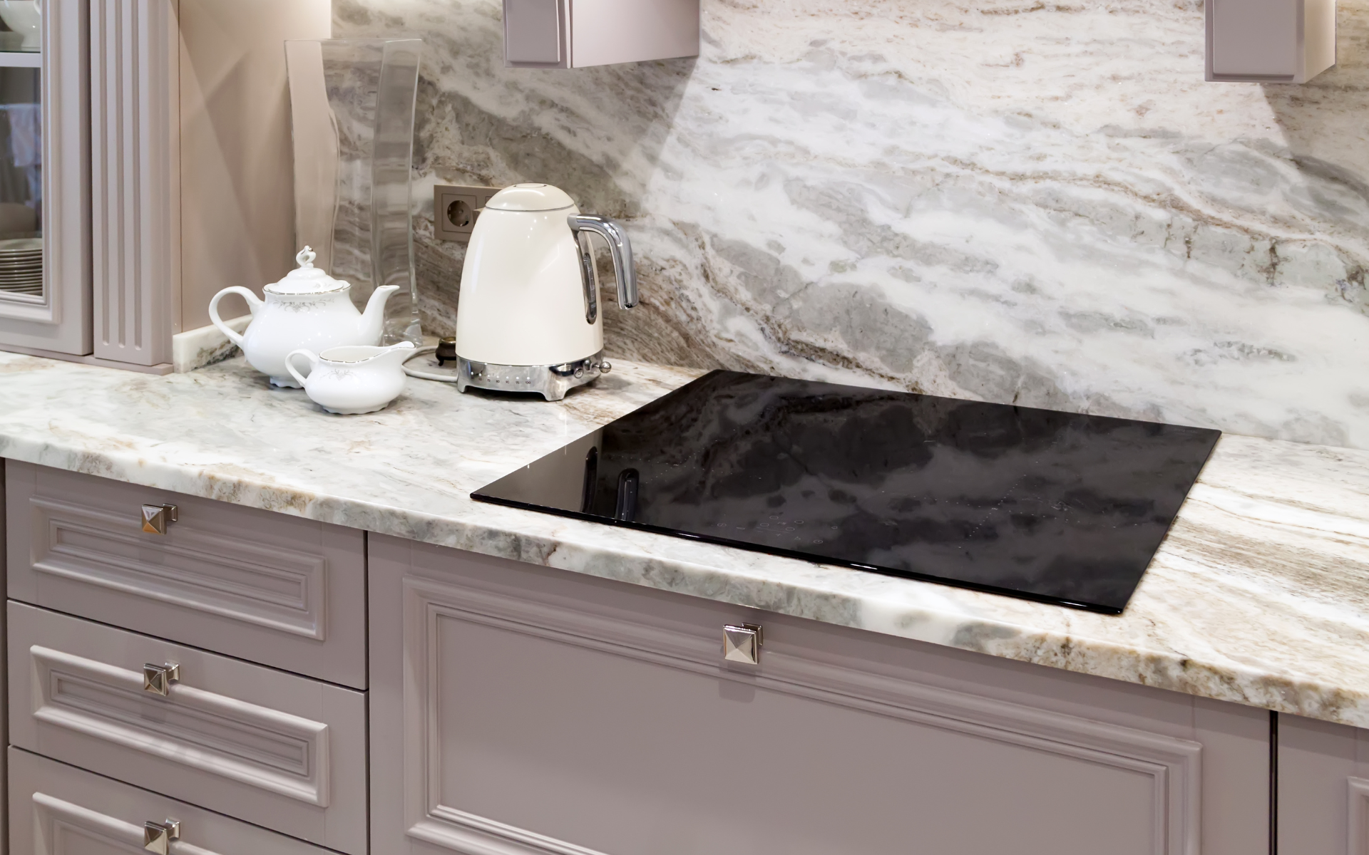 Modern elegant kitchen with beige cabinets and textured backsplash