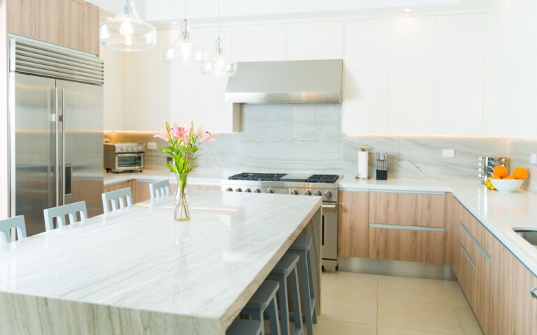 Elegant kitchen with white countertop and white and brown cabinets