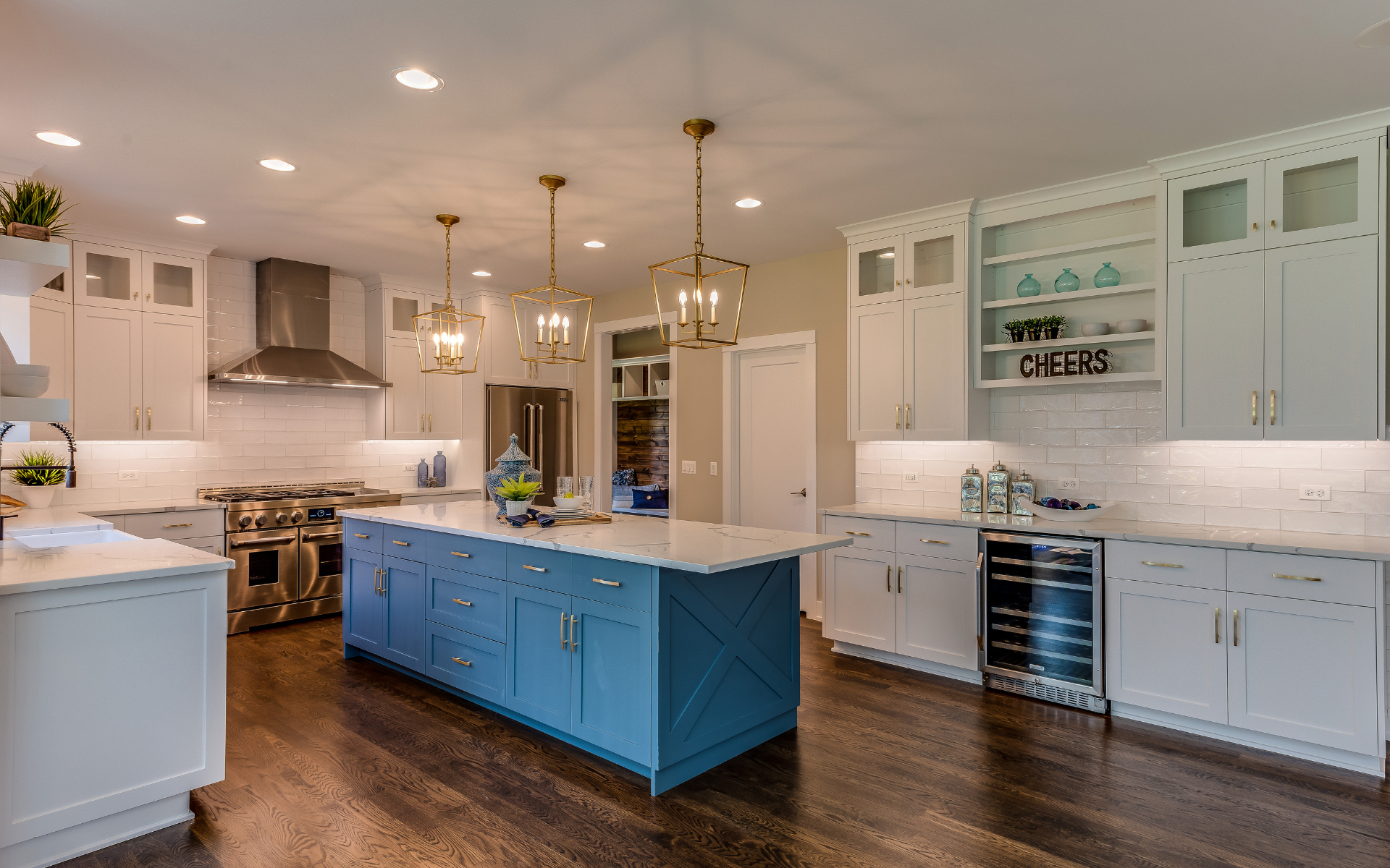 Spacious kitchen with white and blue inset cabinets