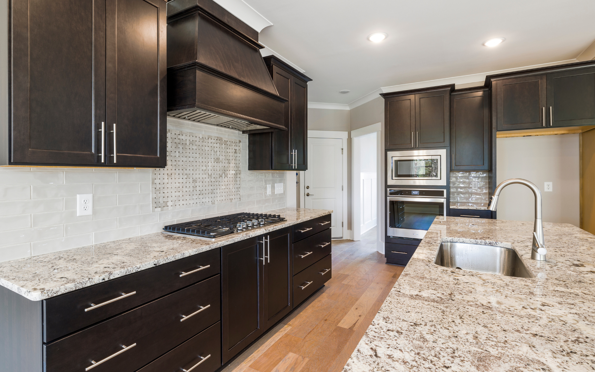 Dark brown kitchen cabinets with natural stone tops