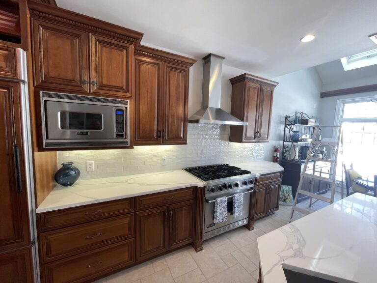 Luxury kitchen remodel with brown traditional cabinets and white quartz countertop