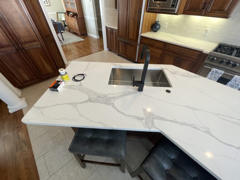 Luxury kitchen remodel with brown traditional cabinets and white quartz countertop