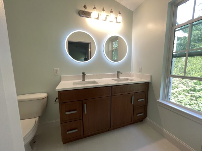 Modern bathroom in Mine Hill NJ with brown double-sink vanity, white quartz countertops, walk-in shower and toilet