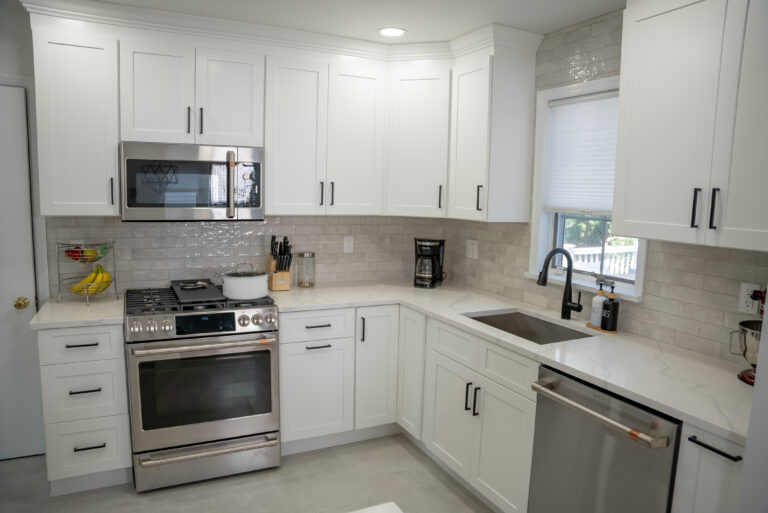 Small kitchen remodel with white shaker cabinets and white quartz countertops