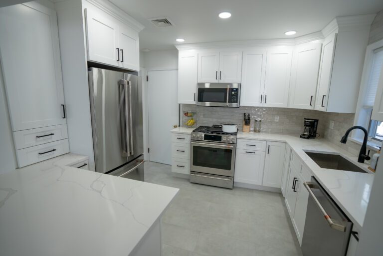 Small kitchen remodel with white shaker cabinets and white quartz countertops