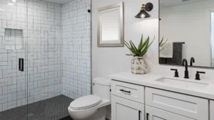 White bathroom with shaker cabinet and undermounted sink on white countertop