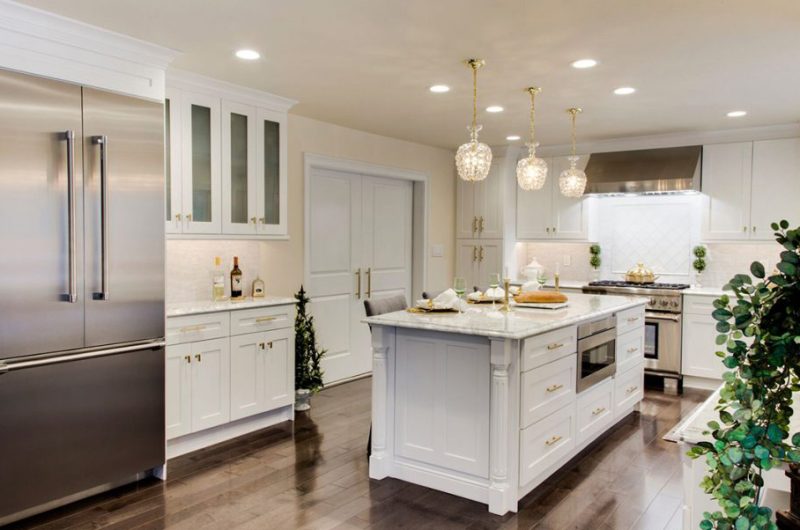 Spacious white kitchen design with white kitchen island top