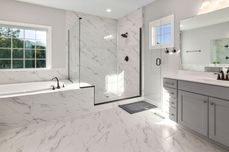 Light grey bathroom cabinets in luxury white bathroom