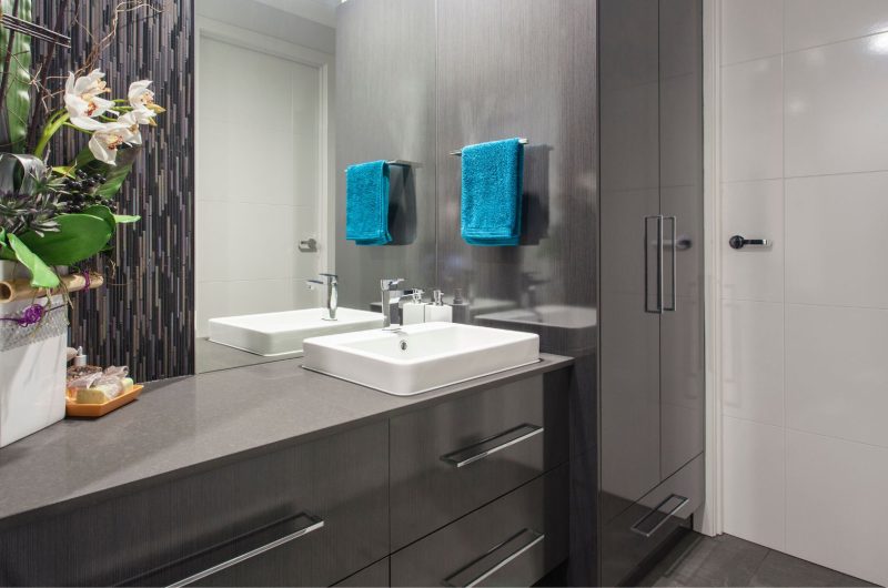 Dark grey bathroom cabinets with light grey countertop