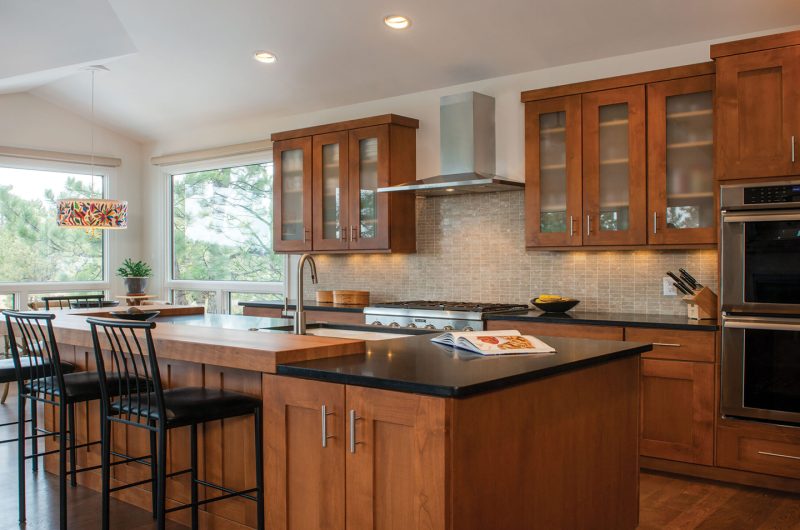 Wood kitchen design with black countertops