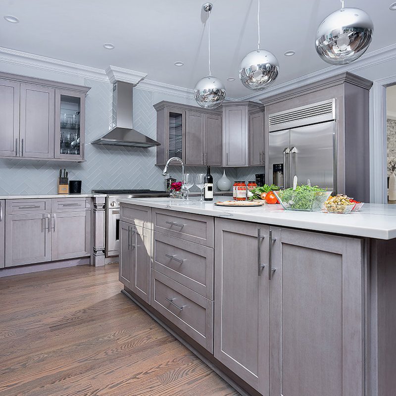 Gray shaker kitchen cabinet with white countertop